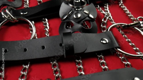 A set of erotic toys for BDSM. Sex slavery game with whip, gag and leather face mask. Intimate sex games leather belts