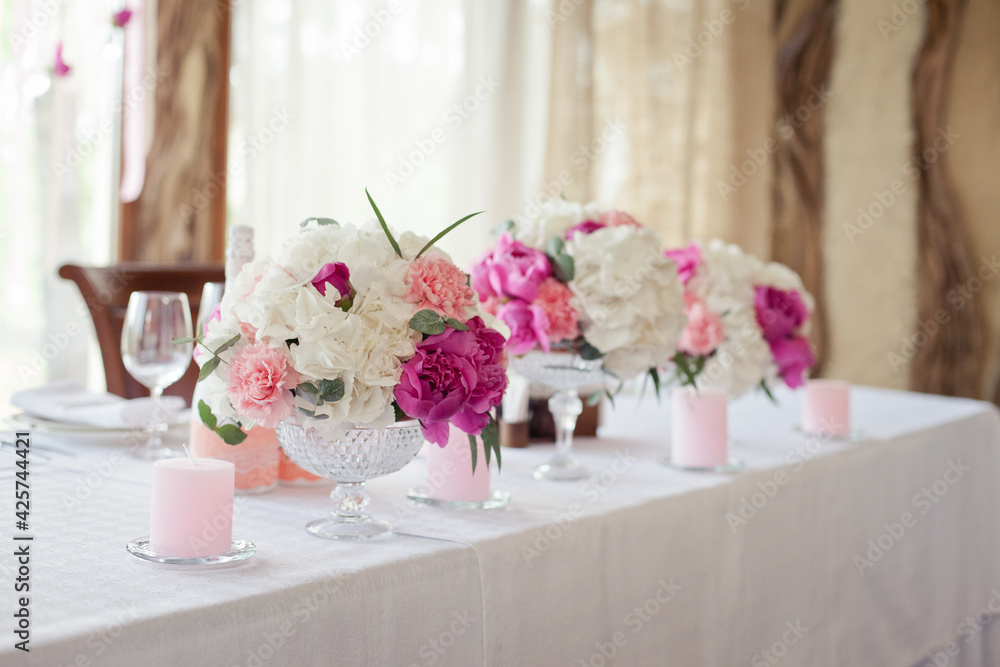 Wedding ceremony decoration in the restaurant. Decoration of wedding table with tender pink textile Wedding ceremony decoration in the restaurant. Decoration of wedding table with tender pink textile