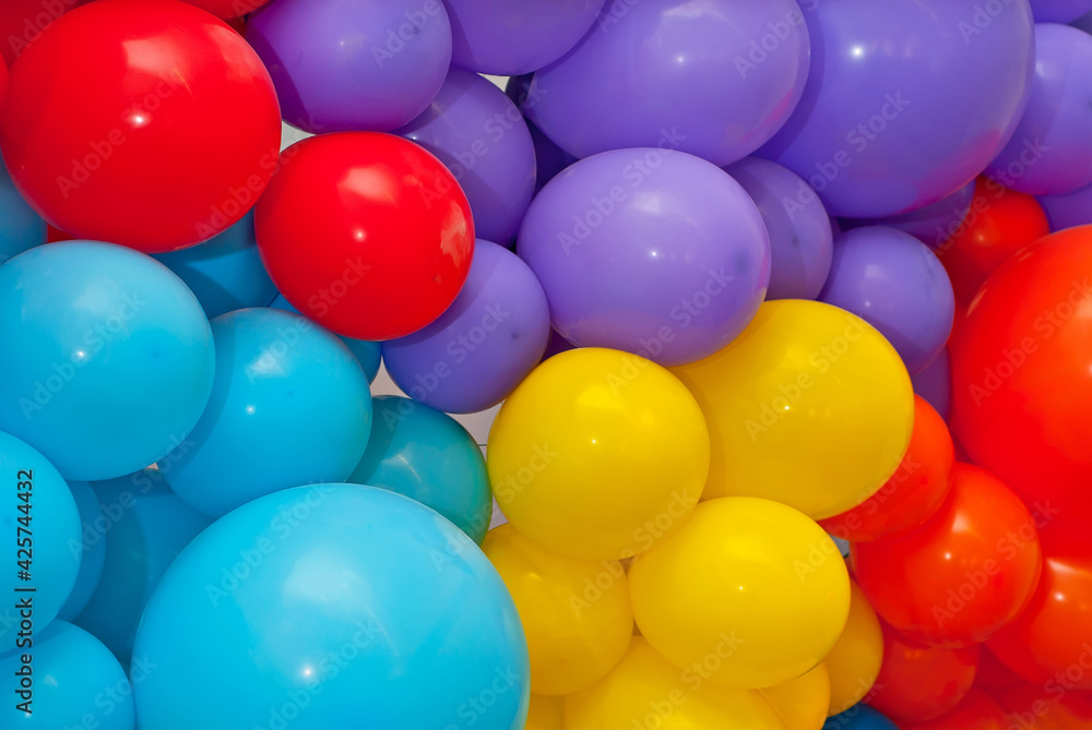 Wall of balloons. Many colorful balls close up. Festive decoration and interior decoration. Photo area for children's holidays. Wall of balloons. Many colorful balls close up. Festive decoration and interior decoration. Photo area for children's holidays.