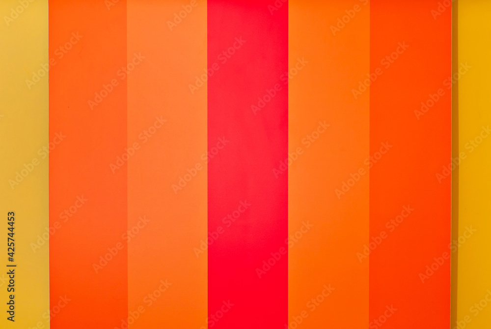 Multicolored strips of paper on the wall. Paper with rainbow colors. Interior design. Multicolored strips of paper on the wall. Paper with rainbow colors. Interior design.