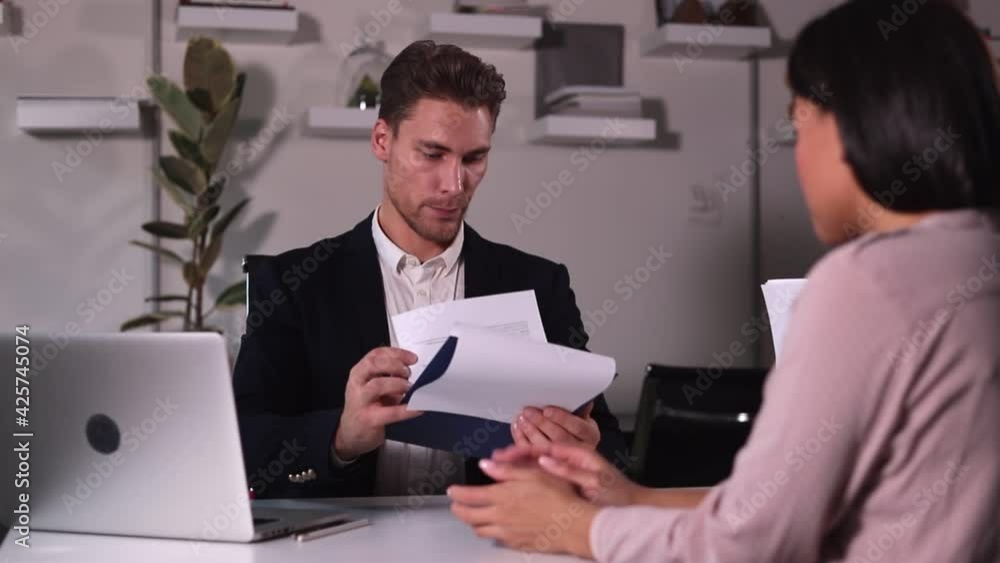 HP specialist man interviews woman for vacancy in large office Spbi.