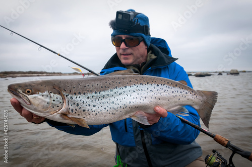 Angler with beautiful silver sea trout