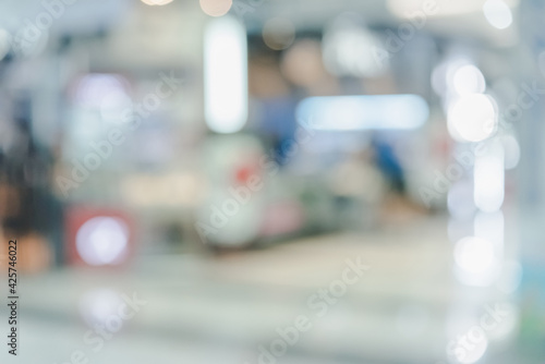 Abstract defocused or blurred background of the shopping mall with nice department store interior. which including of people and shop store.   © czchampz