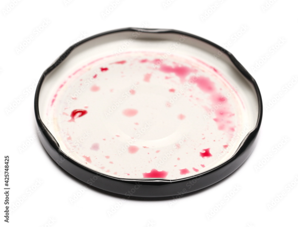 Jar lid with blackcurrant jam, marmalade stains isolated on white background Jar lid with blackcurrant jam, marmalade stains isolated on white background