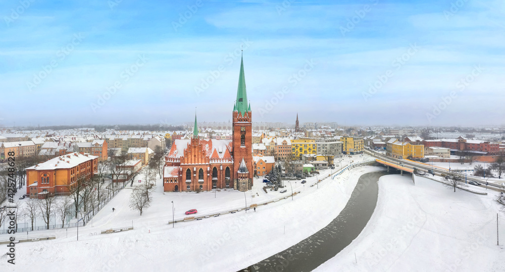 Naklejka premium Legnica, Poland. Panoramic aerial winter cityscape with Saint Jack Sanctuary and Kaczawa river