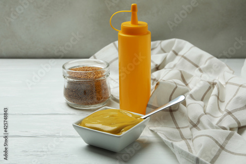 Concept of sauce with mustard on white wooden table