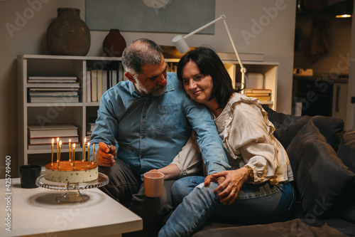 middle aged couple celebrating anniversary at home