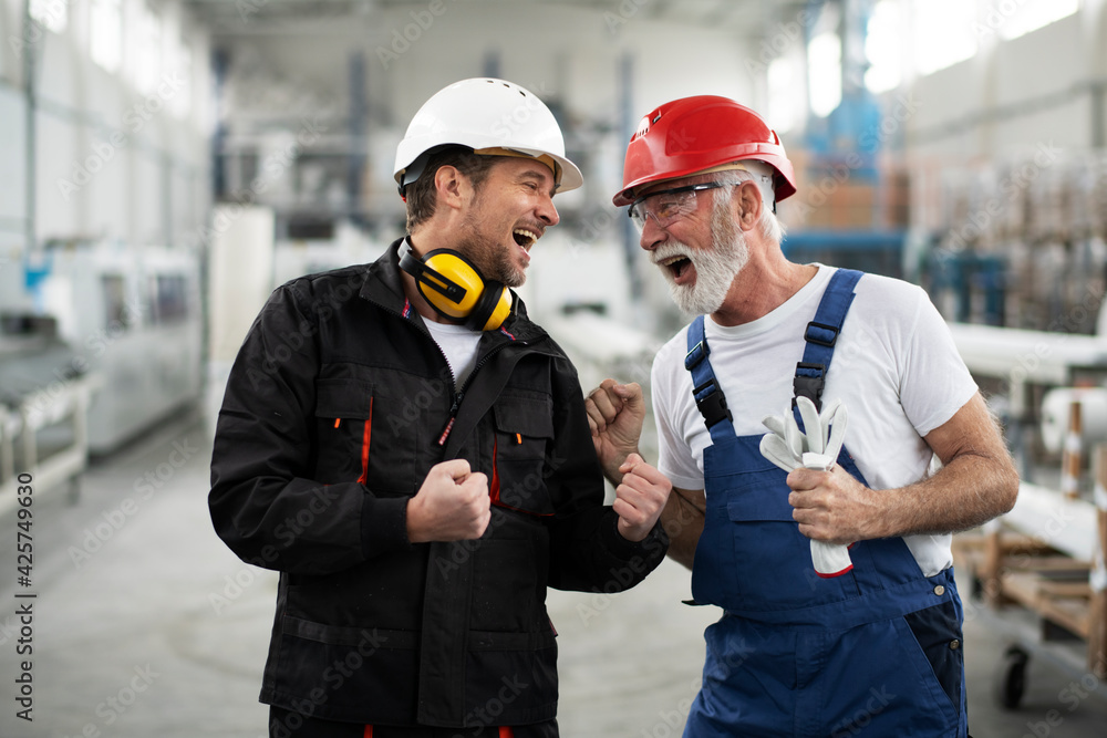 Portrait of workers in factory. Colleagues with helmet working in factory.  Stock Photo | Adobe Stock