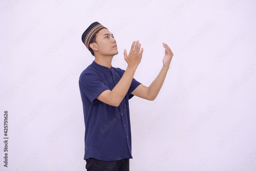 young asian muslim praying to the God isolated white background young asian muslim praying to the God isolated white background