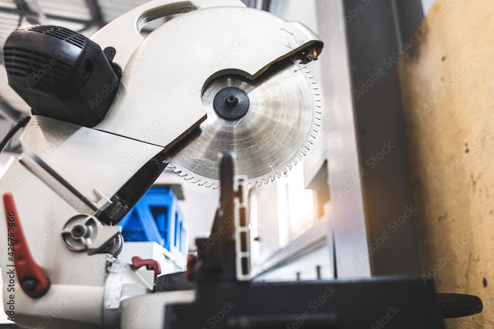 Carpenter cutting flaxboard using sliding compound mitre saw Carpenter cutting flaxboard using sliding compound mitre saw