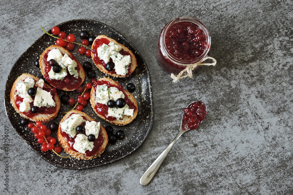 Plate with cheese and jam sandwiches. Toast with currant jam and garganzola cheese. Keto. Plate with cheese and jam sandwiches. Toast with currant jam and garganzola cheese. Keto.