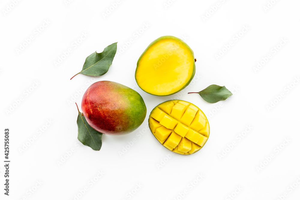 Mango fruit and mango cubes top view. Tropical fruits background