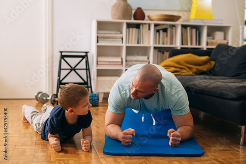 father and son exercise at home