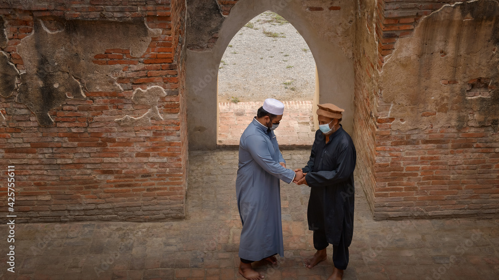 Two Muslim men approached and greeted in an old mosque in Ayutthaya, Thailand.