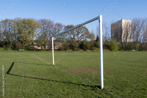 Football goal on public pitch with tower block in background Upton Wirral April 2021