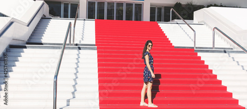 Tourist Woman on the Stairs with Red Carpet in Cannes ,France photo