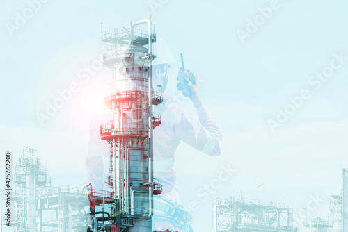 Double exposure of Engineer hand holding walkie talkie, Radio communication, functional control function wearing safety and full safety harness in oil refinery industry plant background