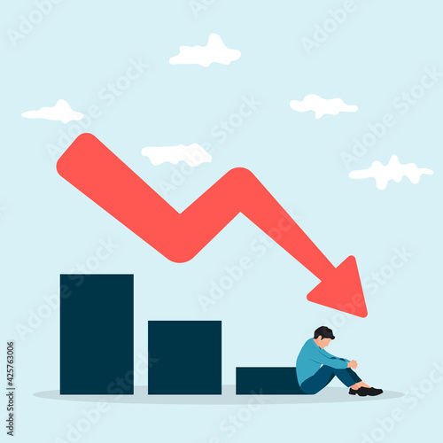 Sitting sad businessman beside a falling chart and arrow down. Business failure and finance crisis concept.