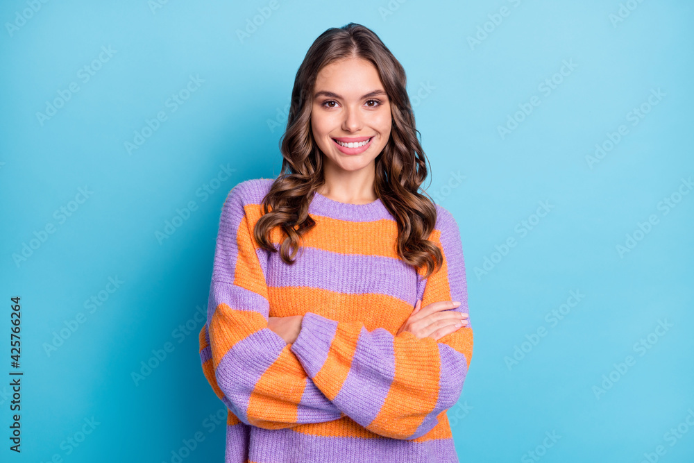 Photo of confident charming young pretty woman folded hands good mood isolated on blue color background Photo of confident charming young pretty woman folded hands good mood isolated on blue color background