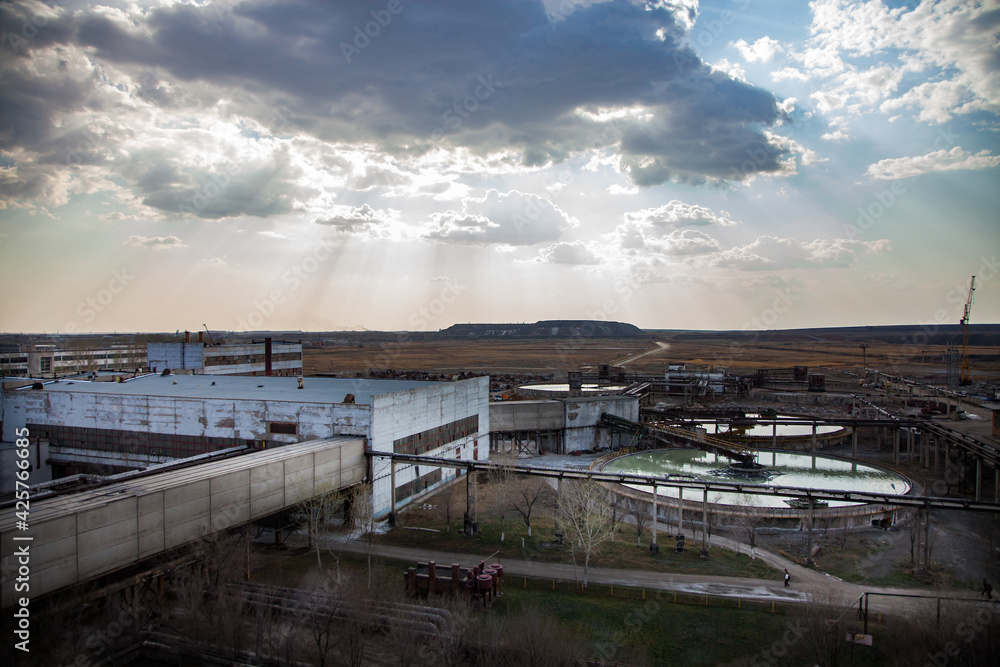 Outdated Soviet mining and processing factory. Water purification plant. Panorama view. Title on building: Labor Glory.