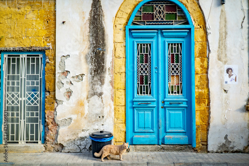 Фотография Facade of typical Cypriot house with shabby ruin windows and doors in town of Ni