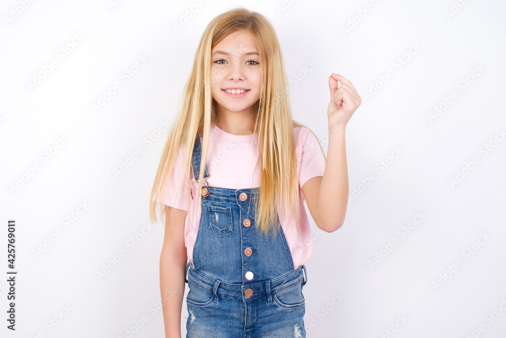 beautiful caucasian little girl wearing denim jeans overall over white background pointing up with hand showing up seven fingers gesture in Chinese sign language QÄ«. beautiful caucasian little girl wearing denim jeans overall over white background pointing up with hand showing up seven fingers gesture in Chinese sign language QÄ«.