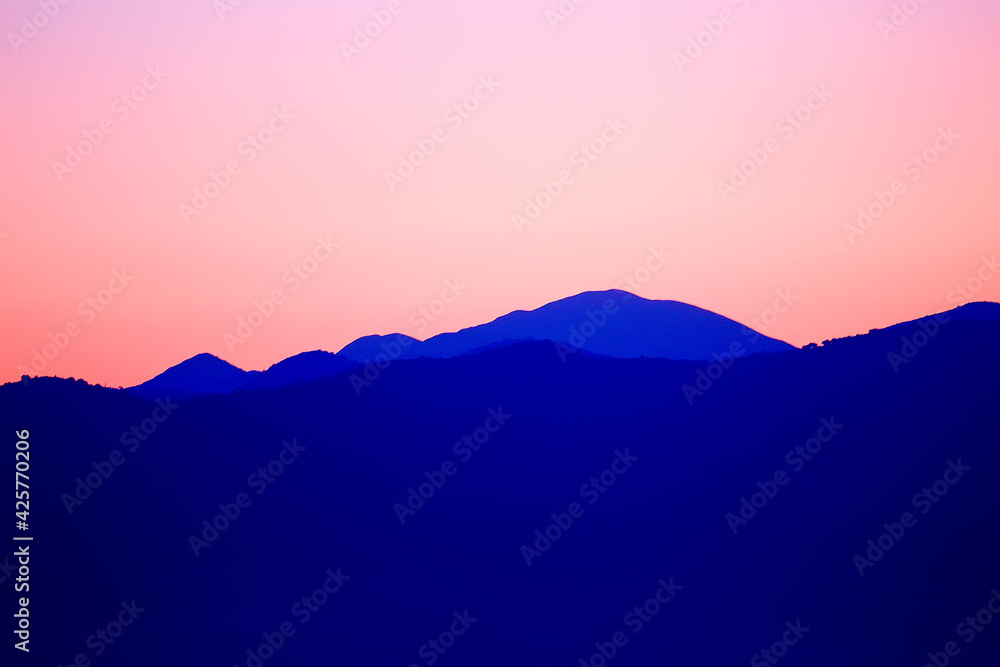 red sunset in the mountains, landscape nature silhouette of mountains at sunset, summer look