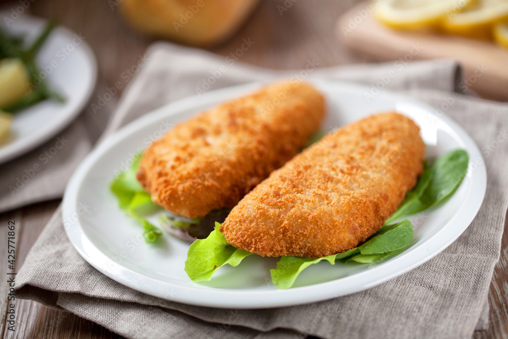 Breaded Fish Fillet With Salad. High quality photo.