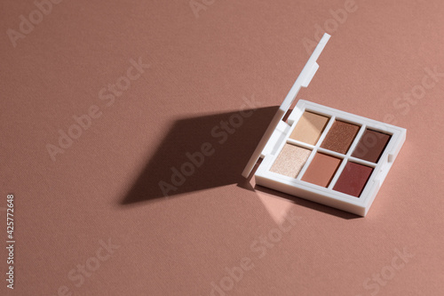 Pastel Eye shadow palette on pink paper clean background with hard light.
