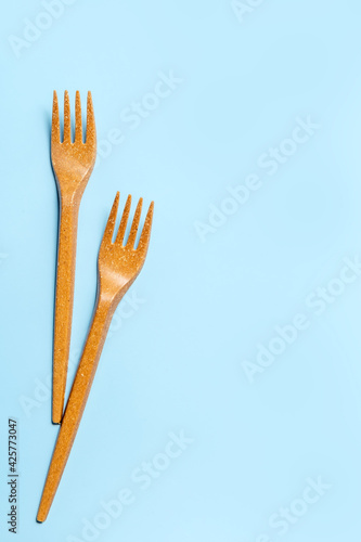 Disposable plastic forks on a blue background. Disposable tableware. Concept. Place for your text. High quality photo