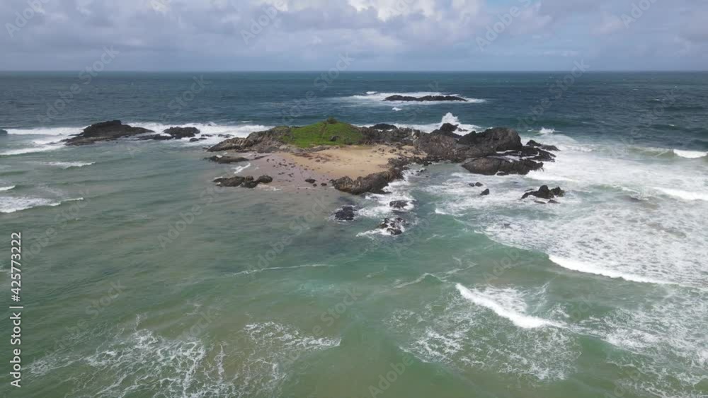 Aerial View Of Island With Sea Waves Near Sawtell Beach At Daytime In NSW, Australia. Aerial View Of Island With Sea Waves Near Sawtell Beach At Daytime In NSW, Australia.