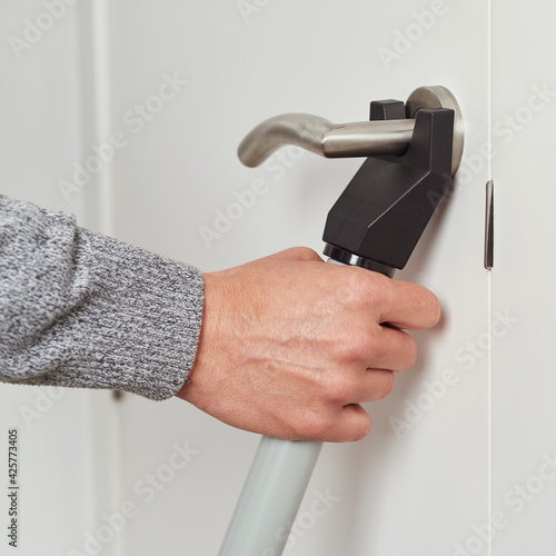 man secures a door with a blocker bar