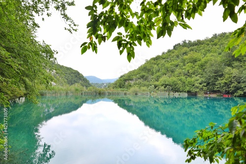 agate green lake with trees and mountains
