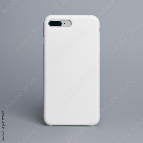 Smart phone on a gray background in a white plastic case back view. Template of iphone case