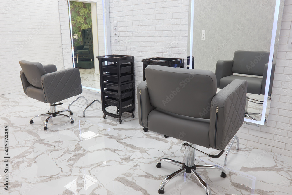 barber chair and mirrors in an elite beauty salon, cosmetologist's office interior