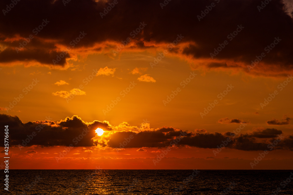 Dramatic sunset over ocean. Sky with clouds. Dramatic sunset over ocean. Sky with clouds.