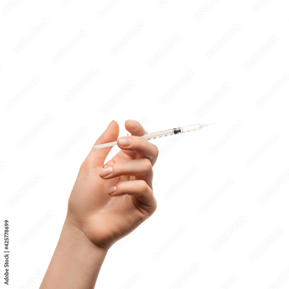 Injection syringe in woman's hand on white background, isolated. Injection syringe in woman's hand on white background, isolated.