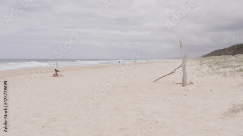 Few People At The Sandy Seashore Of South Gorge Beach In Point Lookout, North Stradbroke Island, QLD Australia. - Wide Shot photo