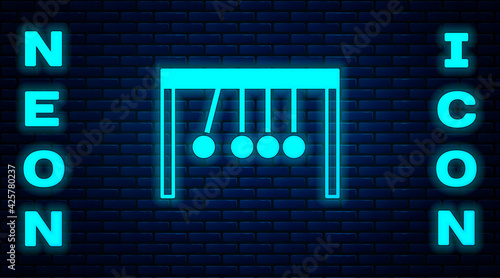 Glowing neon Pendulum icon isolated on brick wall background. Newtons cradle. Vector