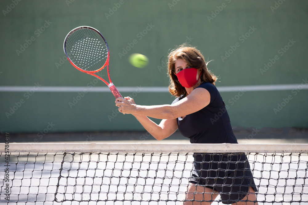 Tennis player in a pandemic season training with great care