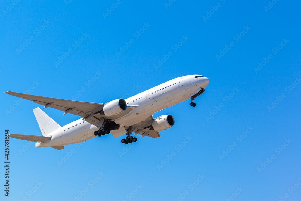 Passenger airplane flying against clear blue sky Passenger airplane flying against clear blue sky
