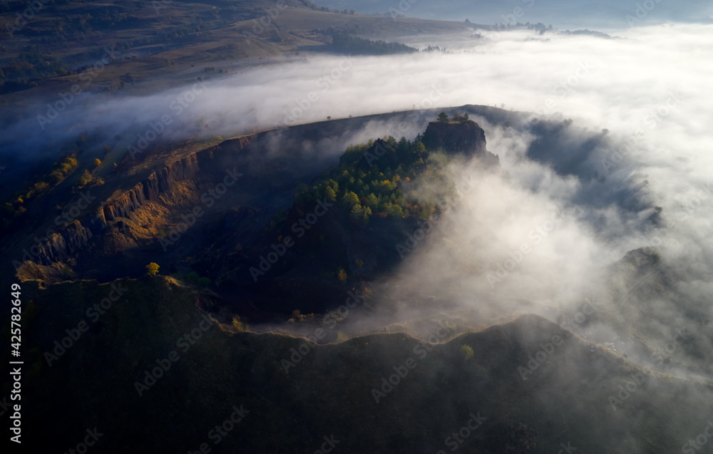 aerial view of volcanic crater in Racos village, Brasov county, Romania - foggy autumn morning