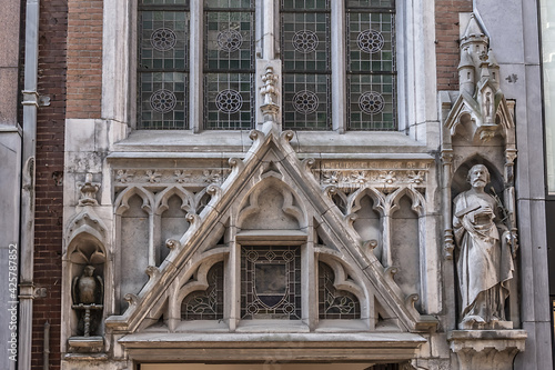 View of Roman Catholic Church 'De Papegaai' (Kerk 'De Papegaai', 1762) in the Kalverstraat. Church 'De Papegaai' - Fifteen minutes to God (Een kwartier voor God). Amsterdam, Netherlands. photo