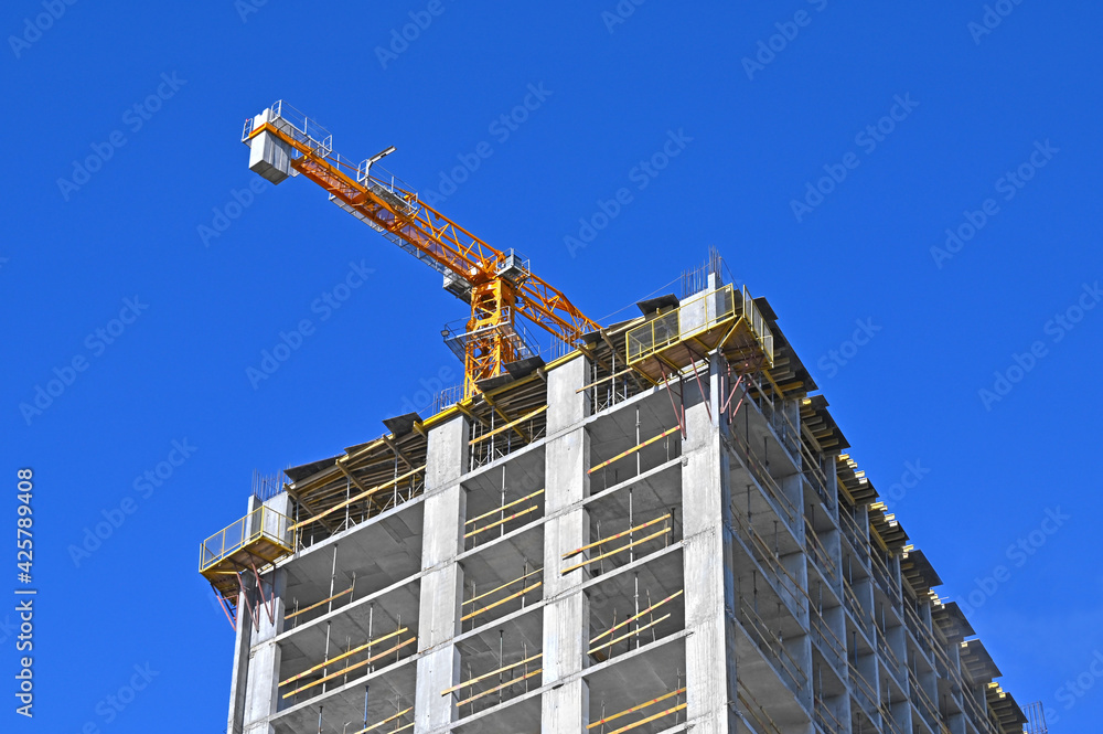 Crane and highrise construction site Crane and highrise construction site