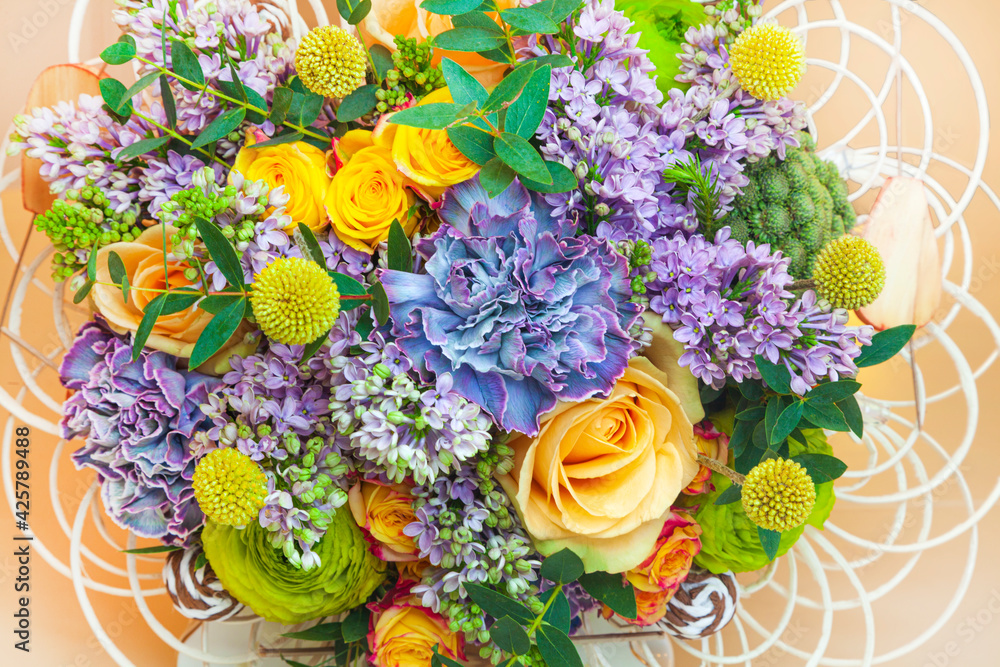 Obraz premium Beautiful spring bouquet, lilac, rose and blue carnation, top view