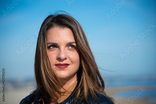 Smiling caucasian young woman with long hair outdoors