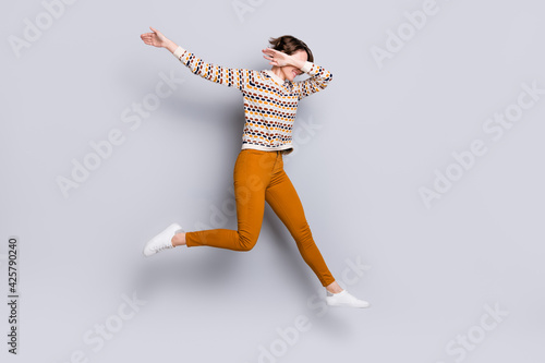 Full length body size view of nice funny cheerful girl jumping dancing dab having fun isolated over grey pastel color background