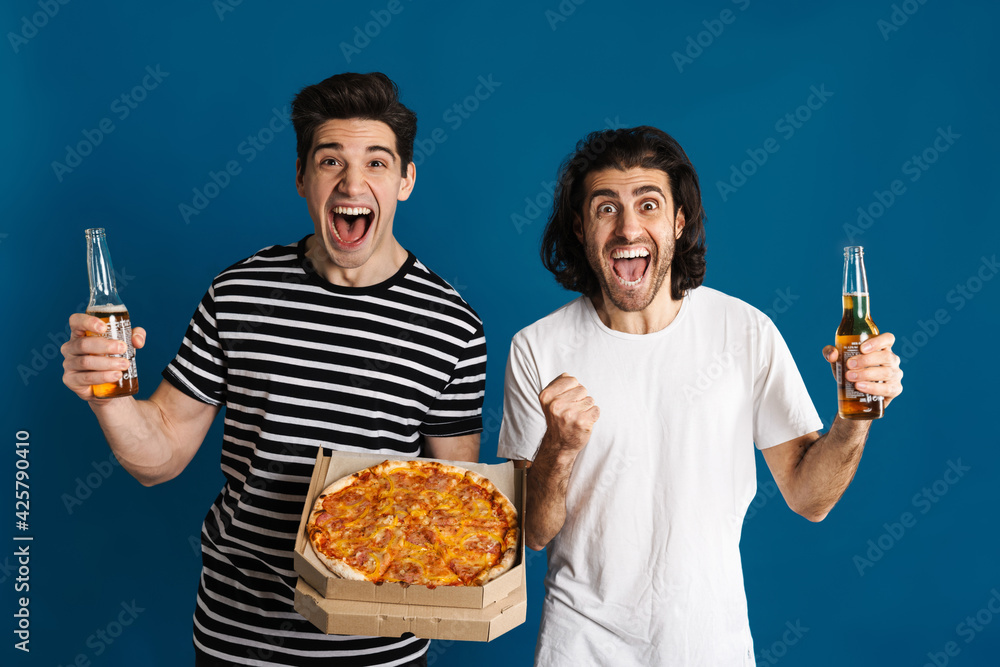 White excited two men screaming while drinking beer and eating pizza White excited two men screaming while drinking beer and eating pizza