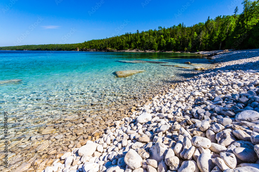 White, stony coastline along lake Huron. Crystal clear water shows limestone rocks. Bruce Peninsula National Park Ontario Canada