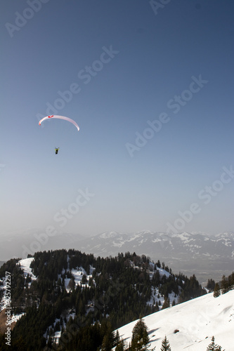 Paraglider in the snowy Allgaeu mountains